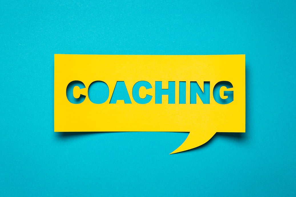 COACHING in Yellow Speech Bubble